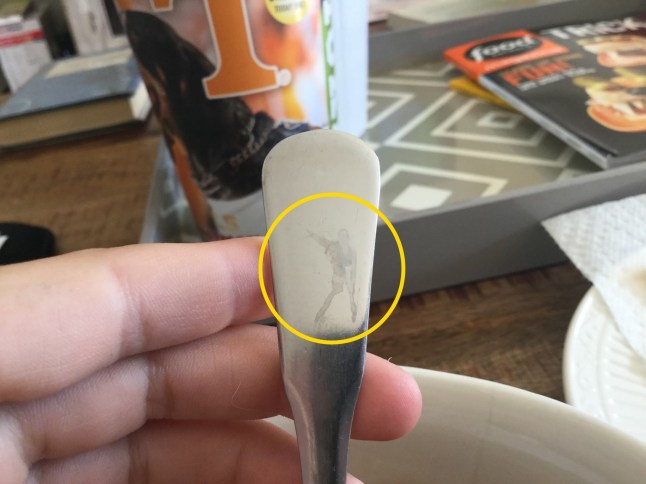 PIC FROM KENNEDY NEWS AND MEDIA (PICTURED: THE SILHOUETTE OF LEGENDARY ROCK SINGER FREDDIE MERCURY NANCY DETRANA SPOTTED IN A TEASPOON HANDLE) A Queen superfan was stunned when she spotted the silhouette of legendary rock singer FREDDIE MERCURY in a teaspoon. Nancy DeTrana's jaw dropped when she saw 'straight away' the Queen frontman's iconic yellow leather jacket pose from the 1986 Wembley tour peeping back from her teaspoon handle. A striking image of the singer's teaspoon twin shows a clear head, body, two legs and the right arm raised, the pose immortalised in the bronze statue that stands in Montreux, Switzerland. DISCLAIMER: While Kennedy News and Media uses its best endeavours to establish the copyright and authenticity of all pictures supplied, it accepts no liability for any damage, loss or legal action caused by the use of images supplied and the publication of images is solely at your discretion. SEE KENNEDY NEWS COPY - 0161 697 4266