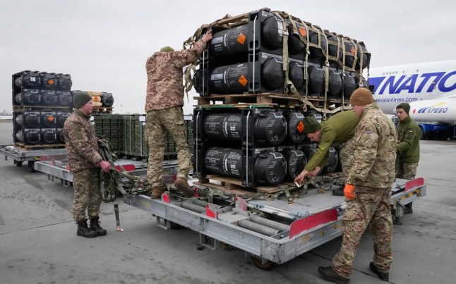 Ukrainian servicemen unpack Javelin anti-tank missiles, delivered as part of the United States of America's security assistance to Ukraine, at the Boryspil airport, outside Kyiv, Ukraine, Friday, Feb. 11, 2022. British Prime Minister Boris Johnson said Thursday the Ukraine crisis has grown into "the most dangerous moment" for Europe in decades, while his top diplomat held icy talks with her Moscow counterpart who said the Kremlin won't accept lectures from the West. (AP Photo/Efrem Lukatsky)