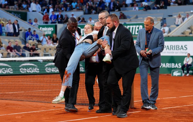 Mandatory Credit: Photo by Javier Garcia/Shutterstock (12960013cq) A protestor is carried away after tying herself to the net during the second semi final French Open Tennis, Day 13, Roland Garros, Paris, France - 03 Jun 2022