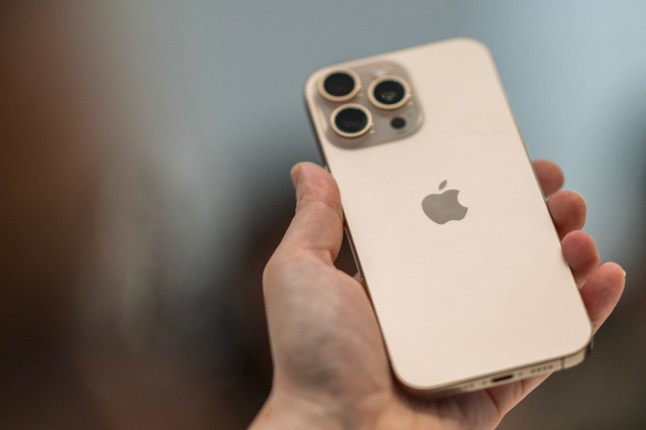 A person holds up a new iPhone 16 Pro following Apple's "It's Glowtime" event in Cupertino, California, September 9, 2024. (Photo by Nic COURY / AFP) (Photo by NIC COURY/AFP via Getty Images) 13867927