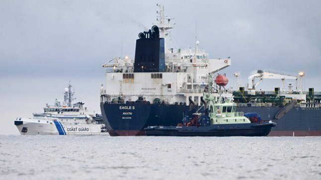 (FILES) In this file photo taken on December 28, 2024 off Porkkalanniemi, Kirkkonummi, in the Gulf of Finland, oil tanker Eagle S (C), which flies under the flag of the Cook Islands, is seen next to Finnish border guard ship Uisko (L) and tugboat Ukko (front R). Estonia has begun naval patrols to protect an undersea cable supplying electricity from Finland following suspected sabotage of another one on Christmas Day, Defence Minister Hanno Pevkur said December 27. In a separate statement, Pevkur said Tallinn wanted to send a clear message that it was ready to protect its power connections with Finland with both military and non-military means. The Estlink 2 submarine cable was disconnected from the grid on December 25, just over a month after two telecommunications cables were severed in Swedish territorial waters in the Baltic Sea. Finnish authorities said on December 26 that they were investigating an oil tanker that sailed from a Russian port over suspected "sabotage". The Eagle S vessel was en route to Port Said in Egypt. (Photo by Jussi Nukari / Lehtikuva / AFP) / Finland OUT (Photo by JUSSI NUKARI/Lehtikuva/AFP via Getty Images)
