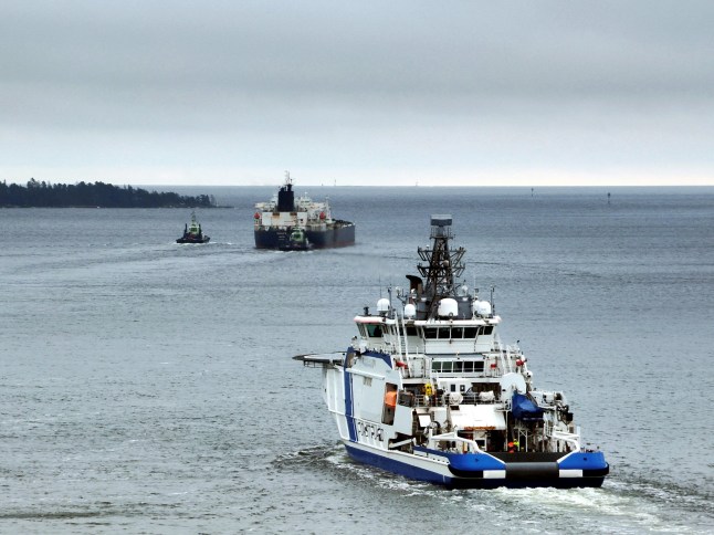 TOPSHOT - This handout picture taken and released by The Finnish Border Guard on March 2, 2025 shows the Border Guard ship Turva (front) escorting Cook Islands registered oil tanker Eagle S out to sea near Porvoo (Borga), Finland. The oil tanker believed to belong to Russia's "shadow fleet" and suspected of sabotaging undersea Baltic cables has been allowed to leave Finland's waters, where it has been held since December, Finnish police said on March 2. The Eagle S is suspected of intentionally dragging its anchor dozens of kilometres along the Baltic seabed, damaging an electrical cable and four telecommunications cables on December 25. (Photo by Handout / various sources / AFP) / - Finland OUT / RESTRICTED TO EDITORIAL USE - MANDATORY CREDIT "AFP PHOTO / FINNISH BORDER GUARD" - NO MARKETING NO ADVERTISING CAMPAIGNS - DISTRIBUTED AS A SERVICE TO CLIENTS (Photo by HANDOUT/Lehtikuva/Finnish Border Guard/AFP via Getty Images)