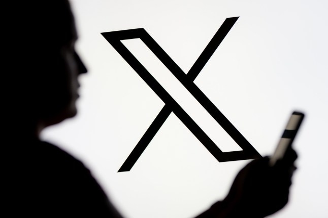 Mandatory Credit: Photo by Mateusz Slodkowski/SOPA Image/Shutterstock (15184737h) In this photo illustration, a woman seen looking at a smartphone with the X (Twitter) logo displayed in the background. Photo illustration in Poland - 07 Mar 2025