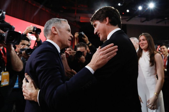 Former Bank of Canada and Bank of England governor Mark Carney and Justin Trudeau embrace after Carney won the race to become leader of Canada's ruling Liberal Party and will succeed Justin Trudeau as Prime Minister, in Ottawa, Ontario, Canada, March 9, 2025. REUTERS/Amber Bracken/Pool TPX IMAGES OF THE DAY