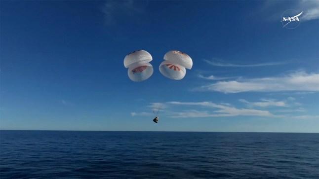 The Crew Dragon capsule containing Butch Wilmore and Suni Williams and two other astronauts descends by parachute before their splashdown, following their return to earth from the International Space Station off the coast of Florida, U.S. March 18, 2025 in a still image from video. NASA TV/Handout via REUTERS. THIS IMAGE HAS BEEN SUPPLIED BY A THIRD PARTY