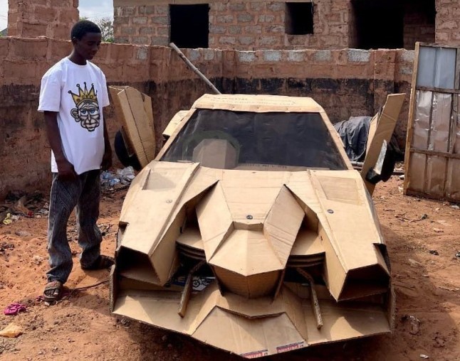Etsenumhe Ahmad pictured with his DIY car made from cardboard. Release date March 21 2025. A teenage automobile enthusiast has built a fully functional Lamborghini-style car entirely out of cardboard. Etsenumhe Ahmad, 18, spent two years constructing the car, which runs on a small motorcycle engine and can reach speeds of up to 40 km/h. Inspired by his love for Lamborghini???s sleek and aggressive design, Etsenumhe crafted the replica using cardboard sourced from bike dealers??? motorcycle packaging. Despite the unconventional material, the car is fully operational. Etsenumhe, from Okpekpe, Edo State, Nigeria, said: ???I chose to style it like a Lamborghini because I???ve always been a fan of their design and performance.