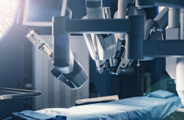 Surgical room in hospital with robotic technology equipment, machine arm surgeon in futuristic operation room. Minimal invasive surgical inoovation, medical robot surgery with 3D view endoscopy; Shutterstock ID 734378278; Purchase Order: -