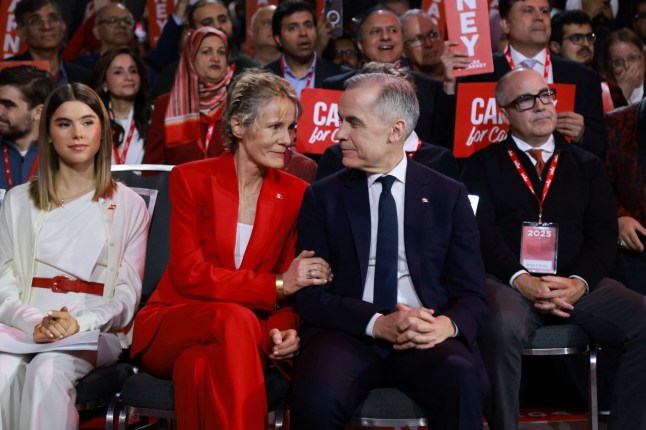 Mark Carney sits next to his wife Diana Fox on the day members of Canada's Liberal Party gather to choose a successor to Prime Minister Justin Trudeau, in Ottawa, Ontario, Canada, March 9, 2025. REUTERS/Carlos Osorio/Pool