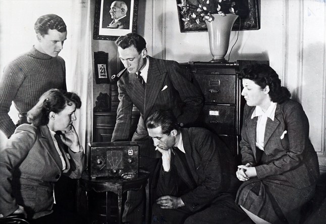 Photograph of Vichy French civilians listen to a radio broadcast by Admiral Jean Darlan (1881 - 1942), French Admiral and political figure. He was Admiral of the Fleet and commander in chief of the French Navy in 1939 at the beginning of World War II. After France capitulated to Nazi Germany in 1940, Darlan served in the pro-German Vichy regime, becoming its deputy leader for a time. (Photo by: Universal History Archive/ Universal Images Group via Getty Images)