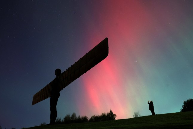 Northern Lights, also known as aurora borealis, are seen at the Angel of the North in Gateshead, Britain, October 10, 2024. REUTERS/Lee Smith