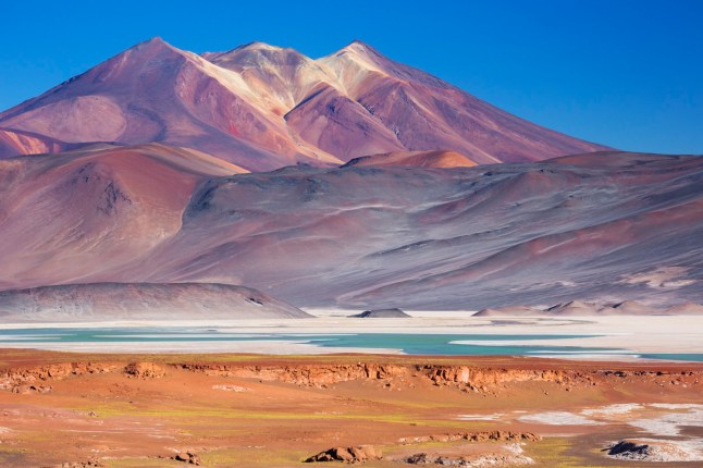 "The salt lake Salar de Talar with surrounding volcanoes in the Atacama Desert, Chile."