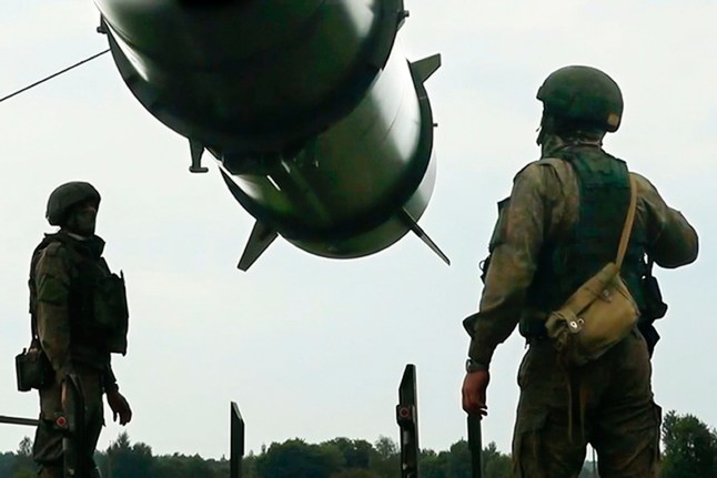 In this photo taken form video released by the Russian Defense Ministry Press Service on Wednesday, June 12, 2024, Russian soldiers load a Iskander-M short-range ballistic missile launchers at a firing position as part of Russian military drill intended to train the troops in using tactical nuclear weapons. (Russian Defense Ministry Press Service via AP)