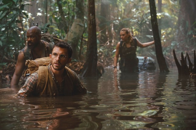 This image released by Universal Pictures and Amblin Entertainment shows, from left, Bechir Sylvain, Jonathan Bailey, and Scarlett Johansson in a scene from " Jurassic World Rebirth."