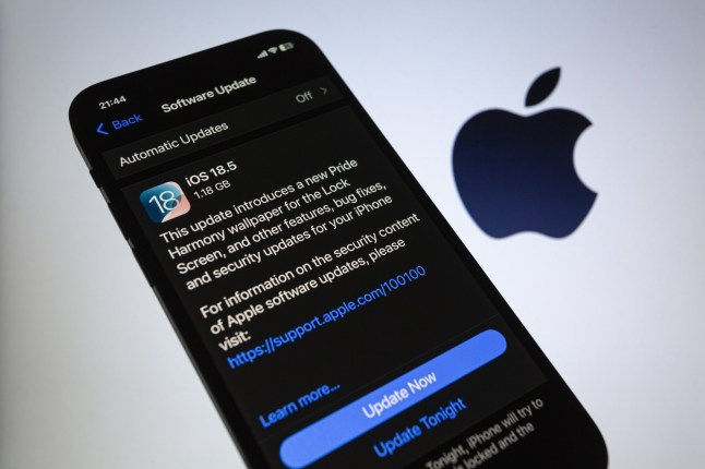 An iPhone screen with iOS 18.5 upgrade prompt from Apple and Apple logo.