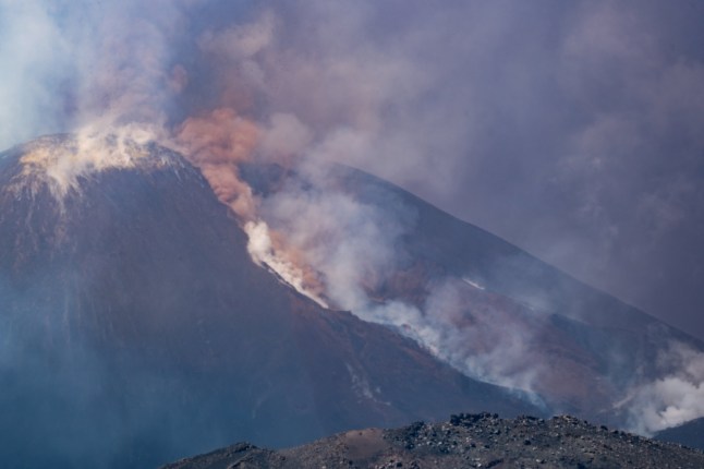 Smoke rises from the crater of the Etna volcano as it erupts, on Mount Etna near Catania on June 2, 2025. A huge plume of ash, gas and rock spewed forth on June 2, 2025, from Italy's Mount Etna, Europe's largest active volcano, after a portion of its southeastern crater likely collapsed, authorities said. (Photo by Giuseppe Distefano / AFP) (Photo by GIUSEPPE DISTEFANO/AFP via Getty Images)