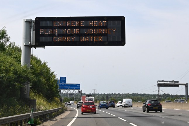 A road sign reads "Extreme Heat, Plan your journey, Carry water", warning motorists about the heatwave forecast for July 18 and 19, on the M11 motorway north of London on July 17, 2022. The UK's meteorological agency on Friday issued its first ever "red" warning for exceptional heat, forecasting record highs of 40 degrees Celsius next week. (Photo by Damien MEYER / AFP) (Photo by DAMIEN MEYER/AFP via Getty Images)