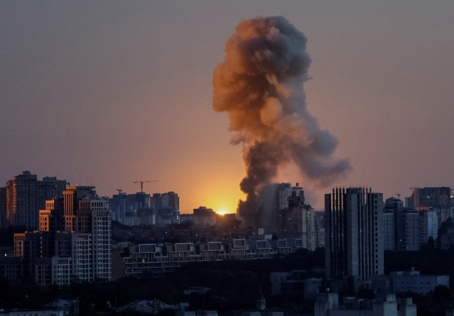 An explosion of a missile lights up the sky over the city during a Russian drone and missile strike