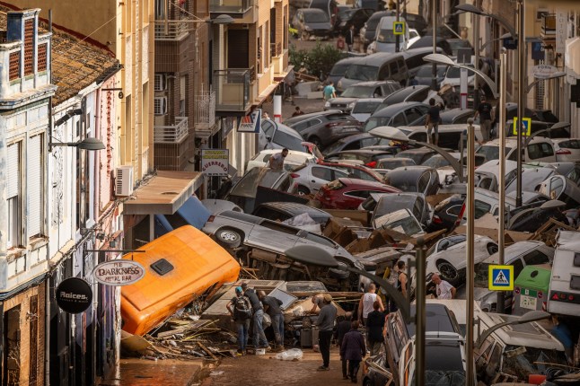 VALENCIA, SPAIN - OCTOBER 30: Cars are piled in the street with other debris after flash floods hit the region on October 30, 2024 in the Sedav?? area of Valencia, Spain. Spanish authorities said on Wednesday that at least 62 people had died in the Valencia region overnight after flash-flooding followed heavy rain. Spain's meteorological agency had issued its highest alert for the region due to extreme rainfall. (Photo by David Ramos/Getty Images)