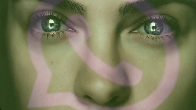 Close up portrait of a woman sat in darkness