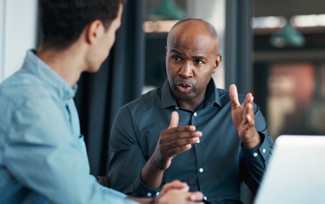 Businessman, leadership and business meeting for teamwork, motivation or collaboration for innovation strategy. Consulting, CEO or mentor working with employee for creative KPI data analytics review