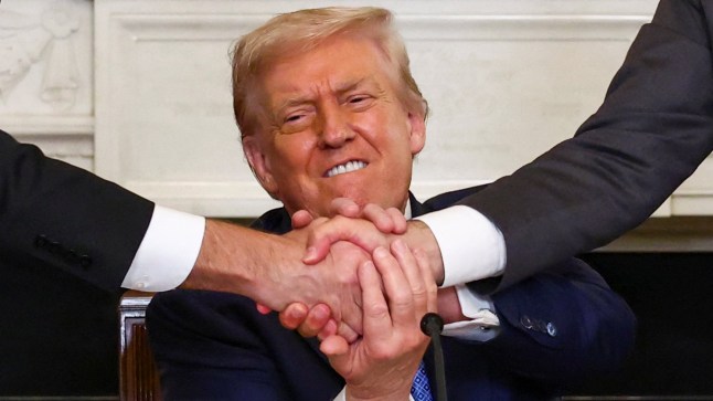 U.S. President Donald Trump holds the hands of Azerbaijan's President Ilham Aliyev and Armenia's Prime Minister Nikol Pashinyan as they shake hands between each other during a trilateral signing event, at the White House, in Washington, D.C., August 8, 2025. REUTERS/Kevin Lamarque