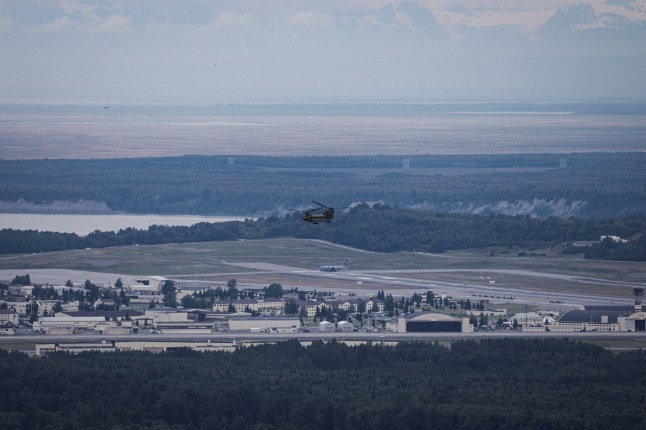 An aircraft flies over Joint Base Elmendorf-Richardson ahead of a planned meeting between U.S. President Donald Trump and Russian President Vladimir Putin to discuss the war in Ukraine, in Anchorage, Alaska, U.S., August 13, 2025. REUTERS/Jeenah Moon