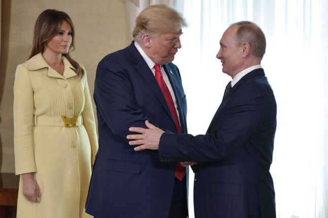 FILE - First lady Melania Trump, left, watches as President Donald Trump and Russian President Vladimir Putin welcome each other at the Presidential Palace in Helsinki, Finland, July 16, 2018, prior to Trump's and Putin's one-on-one meeting. (Alexei Nikolsky, Sputnik, Kremlin Pool Photo via AP)
