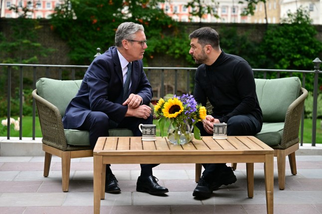 Britain's Prime Minister Keir Starmer (L) talks with Ukraine's President Volodymyr Zelensky in the garden of 10 Downing Street in central London, on August 14, 2025. Ukrainian President Volodymyr Zelensky was metwith ally UK Prime Minister Keir Starmer in London on Thursday ahead of a key US-Russia summit in Alaska. (Photo by Ben STANSALL / AFP) (Photo by BEN STANSALL/AFP via Getty Images)