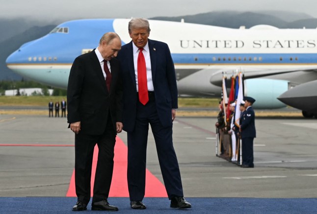 US President Donald Trump (R) and Russian President Vladimir Putin pose on a podium on the tarmac after they arrived at Joint Base Elmendorf-Richardson in Anchorage, Alaska, on August 15, 2025. Putin is in Alaska at the invitation of Trump in his first visit to a Western country since he ordered the 2022 invasion of Ukraine that has killed tens of thousands of people. (Photo by ANDREW CABALLERO-REYNOLDS / AFP) (Photo by ANDREW CABALLERO-REYNOLDS/AFP via Getty Images)