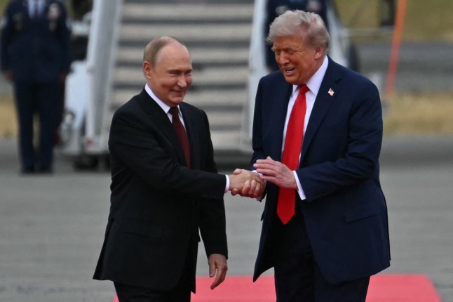 US President Donald Trump greets Russian President Vladimir Putin on the tarmac after they arrived at Joint Base Elmendorf-Richardson in Anchorage, Alaska, on August 15, 2025. Putin is in Alaska at the invitation of Trump in his first visit to a Western country since he ordered the 2022 invasion of Ukraine that has killed tens of thousands of people. (Photo by ANDREW CABALLERO-REYNOLDS / AFP) (Photo by ANDREW CABALLERO-REYNOLDS/AFP via Getty Images)