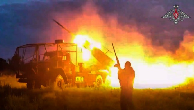In this photo taken from video distributed by Russian Defense Ministry Press Service on Monday, Aug. 18, 2025, a Russian Army BM-21 "Grad" self-propelled 122 mm multiple rocket launcher fires towards Ukrainian position in an undisclosed location in Ukraine. (Russian Defense Ministry Press Service via AP)