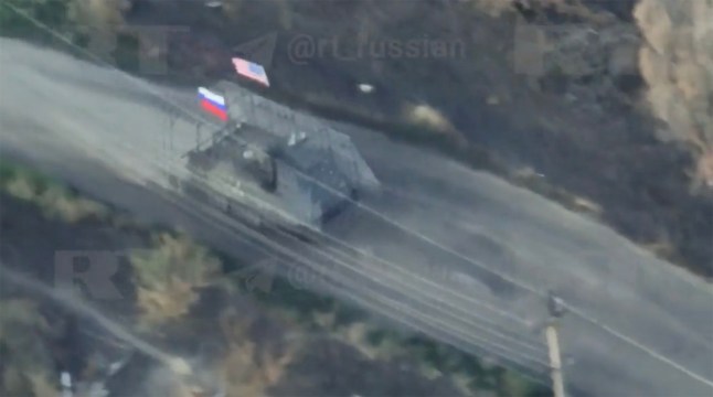 Swaggering Putin troops flying the US and Russian flags after capturing a US M113 armoured personnel carrier from the Ukrainian armed forces near Mala Tokmachka in Zaporizhzhia region.