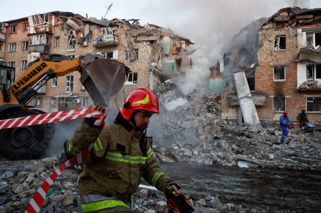Rescuers work at the site of an apartment building which was hit by a Russian missile and drone strike, amid Russia's attack on Ukraine, in Kyiv, Ukraine August 28, 2025. REUTERS/Thomas Peter TPX IMAGES OF THE DAY