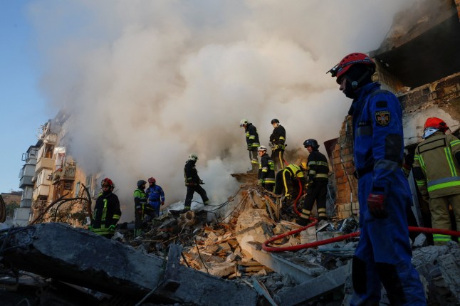 Rescuers work at the site of an apartment building which was hit by a Russian missile and drone strike, amid Russia's attack on Ukraine, in Kyiv, Ukraine August 28, 2025. REUTERS/Thomas Peter