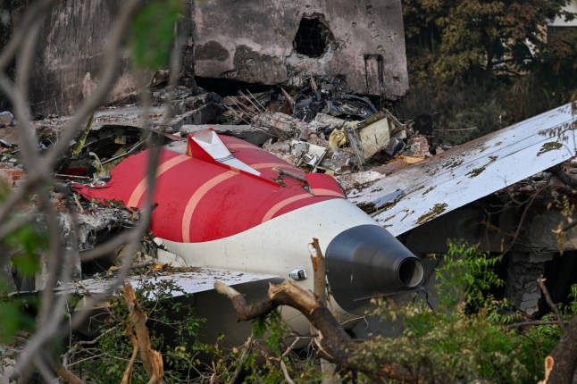 Wreckage showing the tail section of the Air India Boeing 787-8 is pictured in a residential area near the airport in Ahmedabad on June 14, 2025, after the aircraft operating as flight 171 crashed shortly after taking off on June 12. Investigators recovered a black box recorder on June 13 from the crash site of a London-bound passenger jet that ploughed into a residential area of India's Ahmedabad city, killing at least 265 people on board and on the ground. (Photo by Punit PARANJPE / AFP) (Photo by PUNIT PARANJPE/AFP via Getty Images)