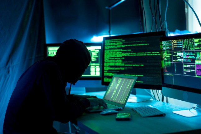 Male Hacker Working On The Laptop And Computer