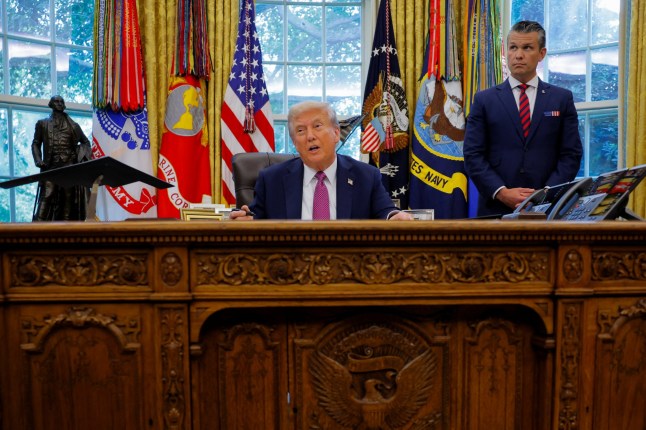 U.S. President Donald Trump, accompanied by U.S. Defense Secretary Pete Hegseth, speaks with the media while signing an executive order in the Oval Office, at the White House in Washington, D.C., U.S., September 5, 2025. REUTERS/Brian Snyder