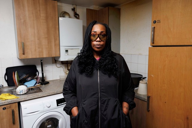 Inside the flat of Remi Olawe, 49, mother of five, which suffers from mould issues and has a broken boiler that the Housing Association has not been able to fix. Remi pictured in the kitchen. (C) Belinda Jiao 07598931257 www.belindajiao.com jiao.bilin@gmail.com