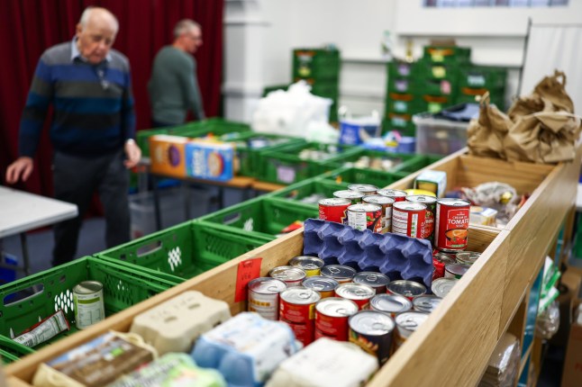 GLASGOW, SCOTLAND - OCTOBER 09: Volunteers and staff sort through food donations at Glasgow South East Food Bank on October 09, 2024 in Glasgow, Scotland. According to a report by the Joseph Rowntree Foundation, the Trussell Trust food bank network saw an 80% increase in emergency food parcels in Scotland in the last two weeks of March 2024, compared to the same period the previous year. Trussell Trust oversees 43 food banks across Scotland, in 26 local authorities. From October 7-13, the UK's Poverty Alliance, in partnership with anti-poverty campaigners and charities, has coordinated events for the annual 'Challenge Poverty Week,' to raise awareness and address the issues around high levels of poverty in Scotland and across the UK. (Photo by Jeff J Mitchell/Getty Images)