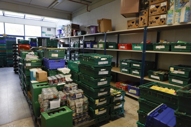 Shelves and crates of supplies at the Cambridge City Food Bank, that distributes food parcels from eight different centers, in Cambridge, UK, on Friday, Oct. 18, 2024. The famed university town is seen across the political spectrum as a model for how to revive the moribund UK economy, but not everyone is sharing in its success. Photographer: Vivian Wan/Bloomberg via Getty Images