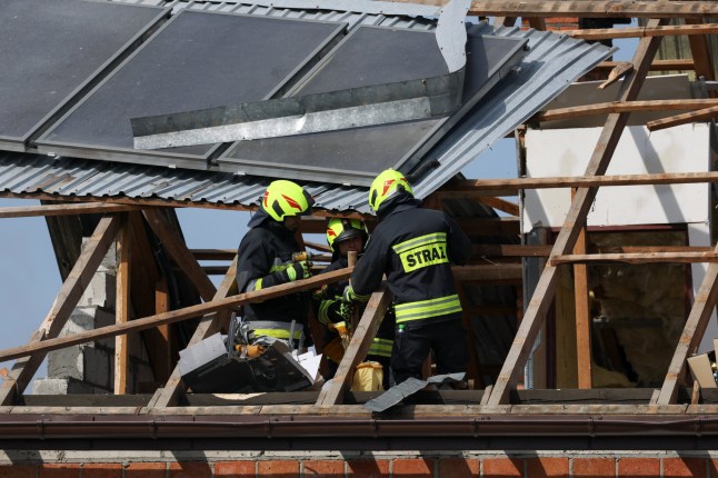 Firefighters work on the destroyed roof of a house, after Russian drones violated Polish airspace during an attack on Ukraine, with some being shot down by Poland with the backing from its NATO allies, in Wyryki, Lublin Voivodeship, Poland, September 10, 2025. REUTERS/Kacper Pempel