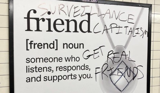 Adverts for ?fake AI friend? you wear as a necklace defaced on subway picture: @normie_egirl