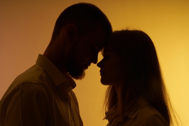 Pair in silhouette  on yellow background.