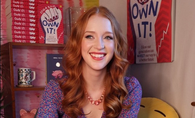 Iona Bain (head/shoulders only) in front of a stack of her book, 'Own It!' (Picture: Iona Bain)