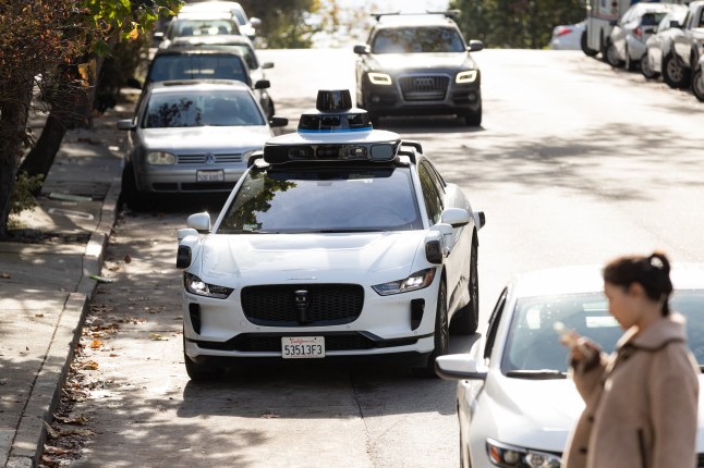 (FILES) A Waymo autonomous vehicle on Steiner Street in San Francisco, on November 17, 2023. The National Highway Traffic Safety Administration (NHTSA) on May 14, 2024, said it had opened an investigation into Google-owned Waymo after reports of 22 incidents with its self-driving technology. The preliminary probe into the robotaxi company will cover the firm's 444 vehicles, according to documents posted on the agency's website. (Photo by Jason Henry / AFP) (Photo by JASON HENRY/AFP via Getty Images)