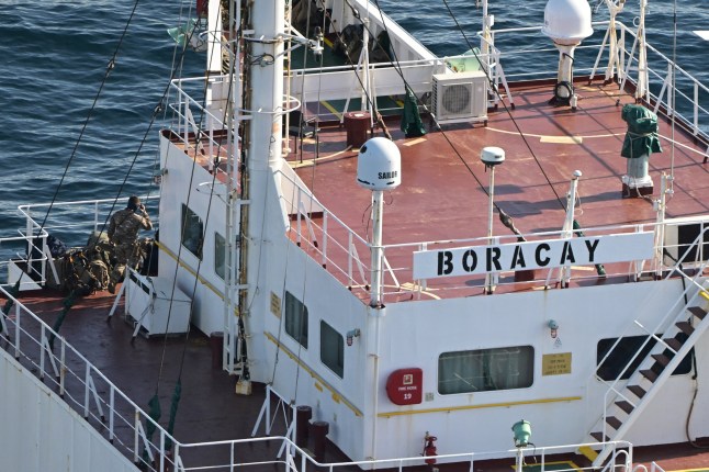 This aerial picture taken on October 1, 2025 off the coast of the western France port of Saint-Nazaire shows French soldiers onboard the tanker from Russia's so-called "shadow fleet" suspected of being involved in drone flights over Denmark which sailed off the Danish coast between September 22 and 25. (Photo by Damien MEYER / AFP)