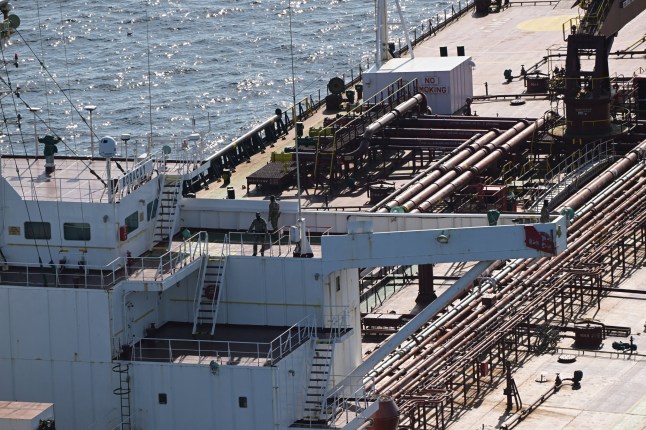 This aerial picture taken on October 1, 2025 off the coast of the western France port of Saint-Nazaire shows French soldiers onboard the tanker from Russia's so-called "shadow fleet" suspected of being involved in drone flights over Denmark which sailed off the Danish coast between September 22 and 25. Named the Pushpa or Boracay, the Benin-flagged vessel, which is blacklisted by the European Union for being part of Russia's sanction-busting "shadow fleet", has been immobilised for several days off the French coast. (Photo by Damien MEYER / AFP) (Photo by DAMIEN MEYER/AFP via Getty Images)