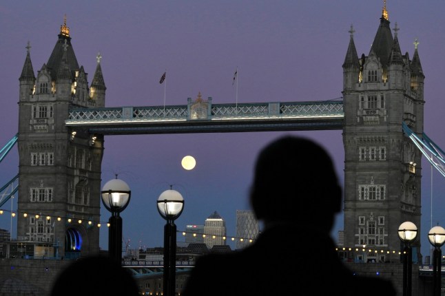 The Harvest Supermoon rises, in London, Monday, Oct. 6, 2025. (AP Photo/Kin Cheung)