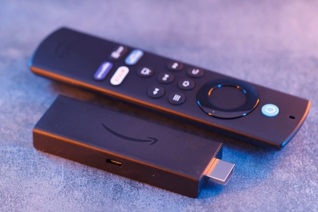 Milan, Italy - January 28, 2024: close up on Amazon Fire Stick Tv device and remote controller for tv streaming.; Shutterstock ID 2424066363; purchase_order: -; job: -; client: -; other: