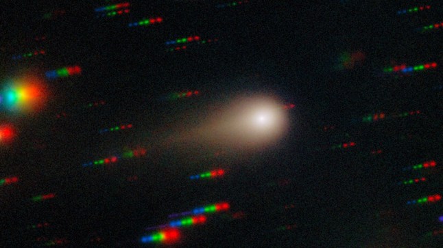 Comet 3I/ATLAS streaks across a dense star field in this image captured by the Gemini Multi-Object Spectrograph (GMOS) on Gemini South at Cerro Pach??n in Chile, one half of the International Gemini Observatory, partly funded by the U.S. National Science Foundation (NSF) and operated by NSF NOIRLab. This image is composed of exposures taken through four filters ??? red, green, blue and ultraviolet. As exposures are taken, the comet remains fixed in the center of the telescope???s field of view. However, the positions of the background stars change relative to the comet, causing them to appear as colorful streaks in the final image. See a version of the image where the stars have been ???frozen??? here. These observations of Comet 3I/ATLAS were conducted during a Shadow the Scientists program hosted by NSF NOIRLab. A full recording of the session can be found here.